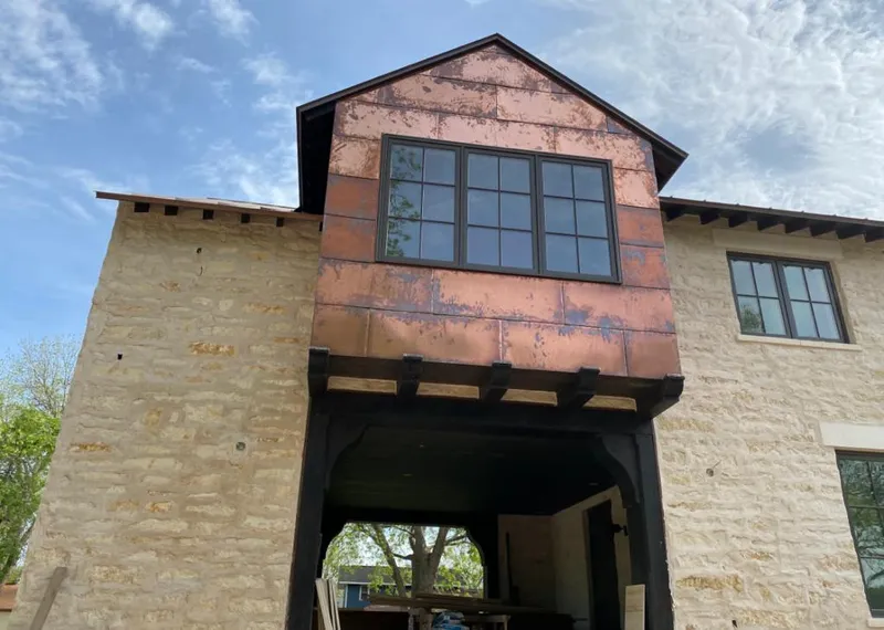 Copper metal panel facade on a stone building for Skylight Installation in Atwater